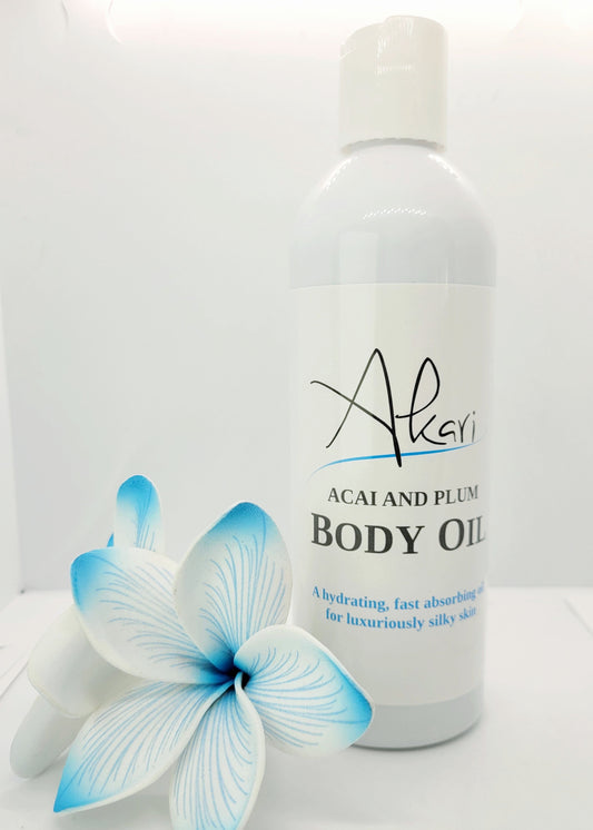 Body oil bottle with floral design on a white background
